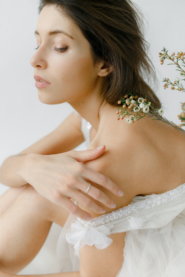 Woman’s bare shoulder with flowers. 